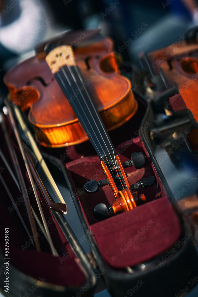 Fototapeta premium Abstract blurred background of Violin and bow in dark red case. Classical music concept