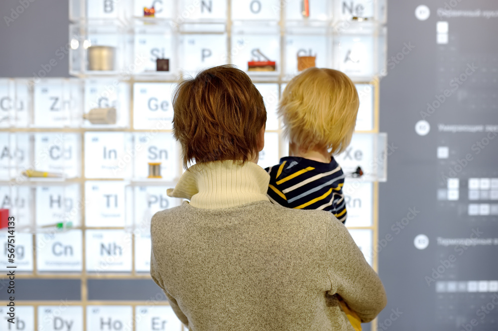 Little boy and woman looking an exposition in a scientific museum. Child is interested in chemistry. Education and entertainment for children. Activities for family with kids. Little boy and woman looking an exposition in a scientific museum. Child is interested in chemistry. Education and entertainment for children. Activities for family with kids.