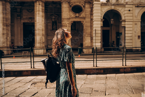 A beautiful woman walks with backpack in Turin, Italy. © ln_a