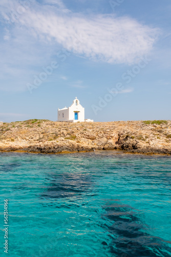 Tiny church with blue door on Island in Greece photo