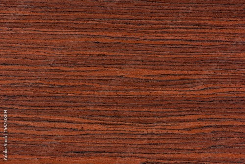 Rosewood texture. Texture of dark mahogany with an intense pattern, natural rosewood veneer for the production of furniture or yacht decoration