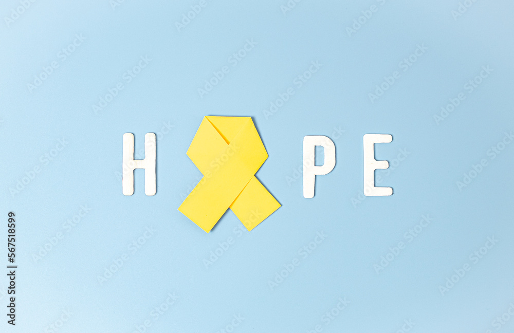 Yellow ribbon in the word hope on a blue background. Yellow ribbon in the word hope on a blue background.