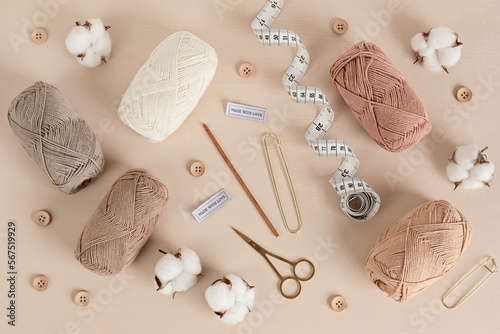 Craft knitting hobby background with yarn in natural colors. Recomforting hobby to reduce stress for cold fall and winter weather. Mock up, copy space, top view