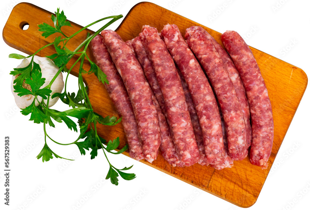 Fresh sausages longaniza on chopping board. Isolated over white background