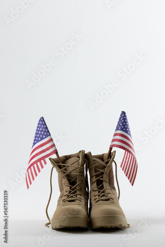 Military boots with flags of usa on white background, with copy space