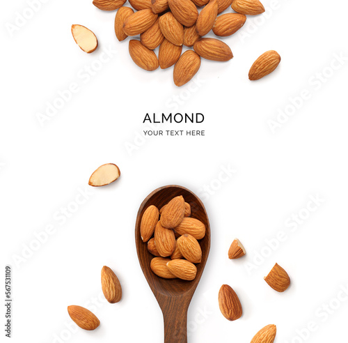 Creative layout made of almonds and wood spoon on a white background. Top view.  
