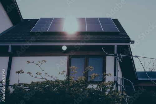 Solar panels on the roof of a building, active at day. cute realistic village...