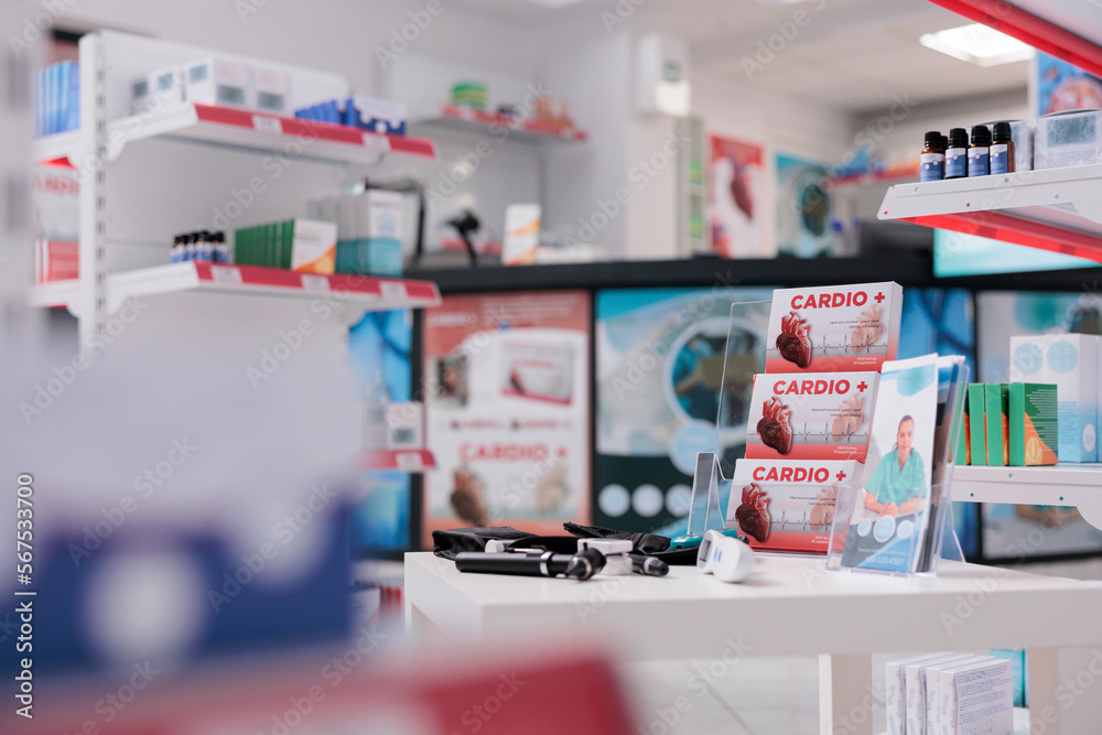 Cardiology drugs pacakages standing on table in empty drugstore, pharmacy equipped with medical instruments. Health care facility with nobody in it filled with pharmaceutical products and vitamins