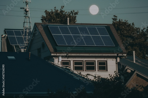 Solar panels on the roof of a building, active at day. cute realistic village...