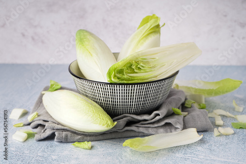 Vászonkép Bowl of fresh endive on light background