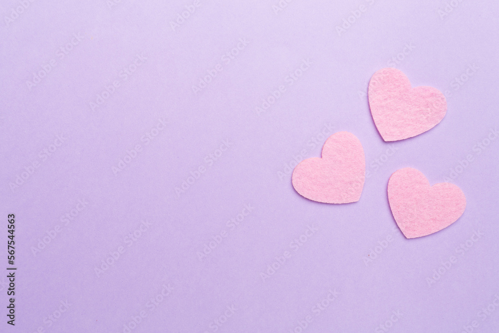 Felt hearts on color background, top view