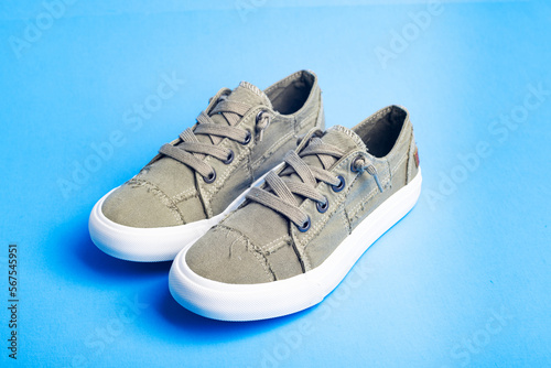 sneaker on blue background. Fashionable stylish sports casual shoes. Mock up for design advertising for shoe store