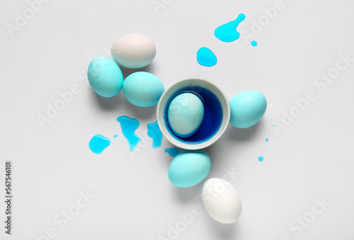 Fototapeta Naklejka Na Ścianę i Meble -  Beautiful Easter eggs and bowl of dye on white background