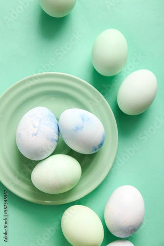 Plate of beautiful Easter eggs on color background  closeup