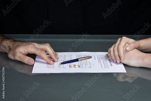 Couple goes through divorce signing papers. High quality photo