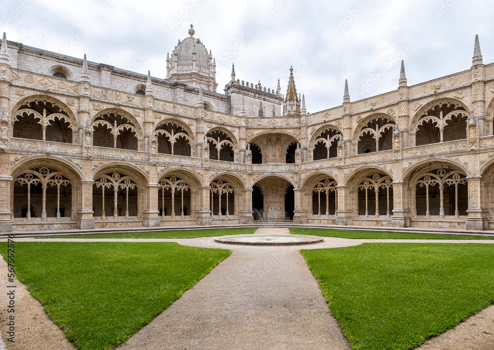 cloister of the monastery of los jeronimos with its balconies with gothic style arches and a fire in the center of the temple, Belem, lisbon Portugal