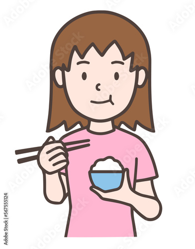 お茶碗を持って、ご飯を食べる女性