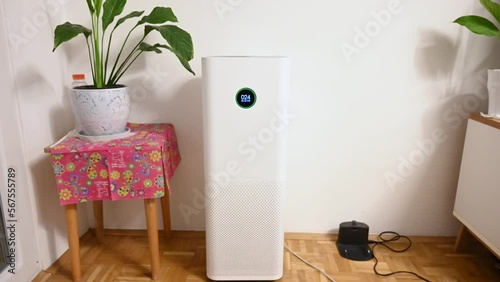 Air purifier with filter in living room. Digit numbers on modern air purifier in apartment.  photo