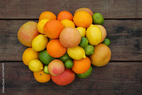 Different citrus fruits on wooden table, flat lay