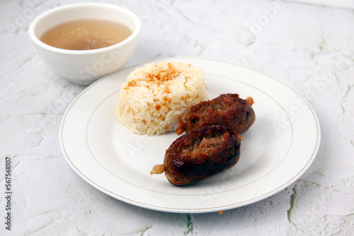 Freshly cooked Filipino food called Longganisa or cured pork sausage and fried rice photo