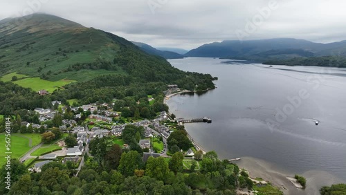 Aerial Pan Around Luss Village Next to Loch Lomond with Cloud Covered Ben Lomond in the Background. Scottish Highlands photo