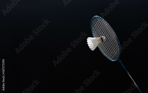 slow motion of the shuttlecock falling on the badminton racket black background black background © noprati