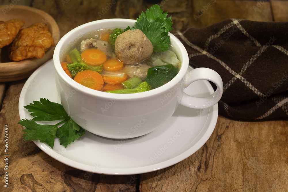 vegetable and meatball soup with tempeh side dish on old wooden background vegetable and meatball soup with tempeh side dish on old wooden background