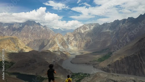 Drone shot passing two hikers on top a mountain cliff, Kakshaal Too mountain range in Kyrgyzstan photo