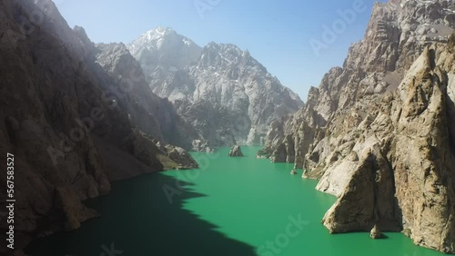 Epic cinematic drone shot going through a large ravine over the Kel-Suu lake in Kyrgyzstan photo