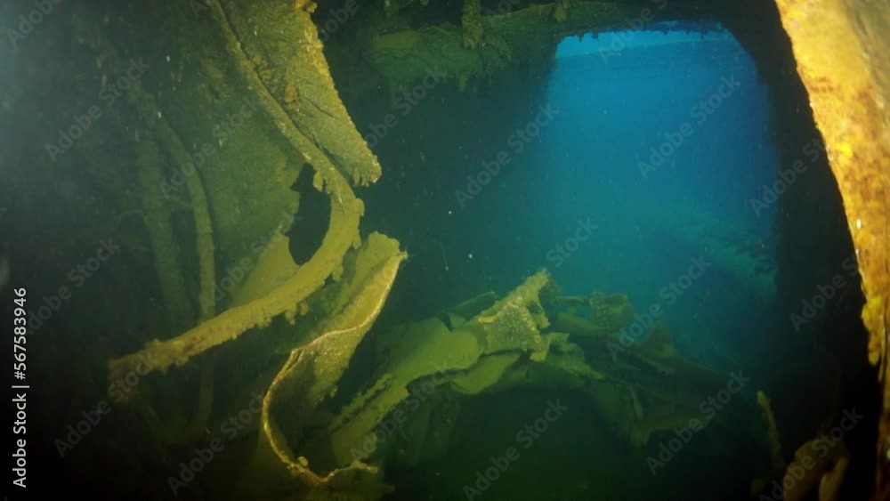 Wreck inside view in underwater submarine world of ships from World War II as result of military battles on Truk Islands. Concept of diving in historic underwater sites of sunken shipwreck.