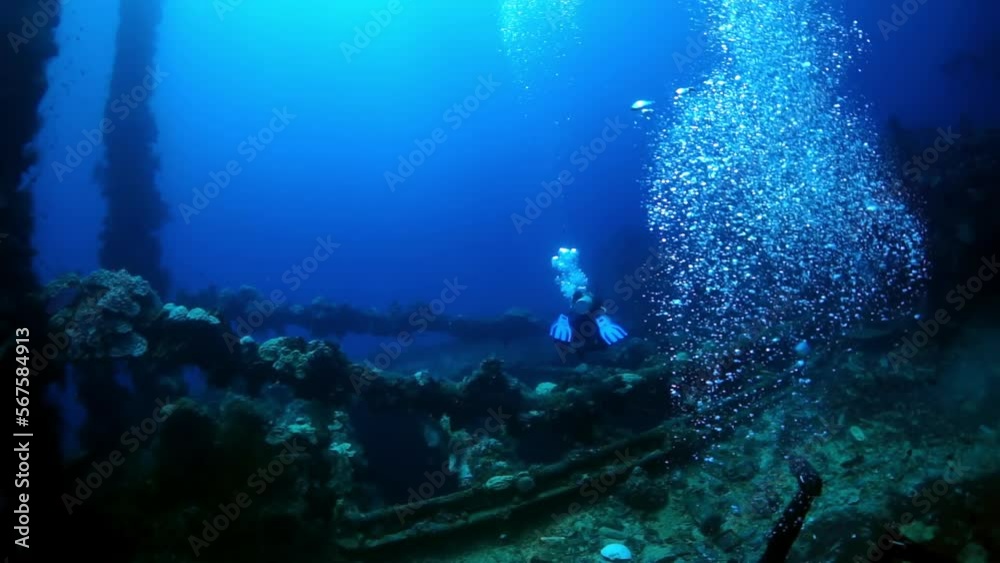 Diving in Truk Lagoon of shipwreck on Chuuk Islands. Ship wreck in sea life of Truk. Inside view of wreck in blue lagoon.