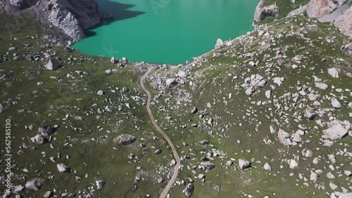 Epic cinematic aerial shot starting on a trail revealing the Kel-Suu lake in Kyrgyzstan photo