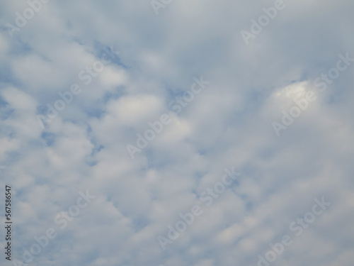 White clouds are layered in the blue sky for background and decorate wallpaper
