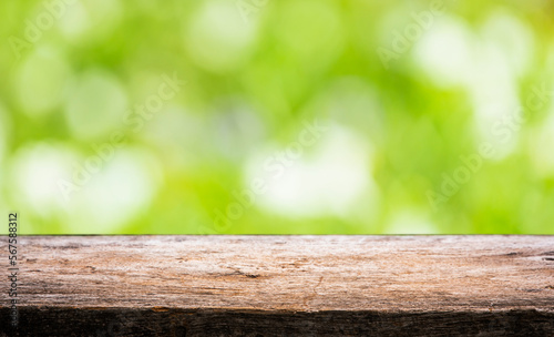 wooden floor with bokeh blur of nature park background and summer for your display montages