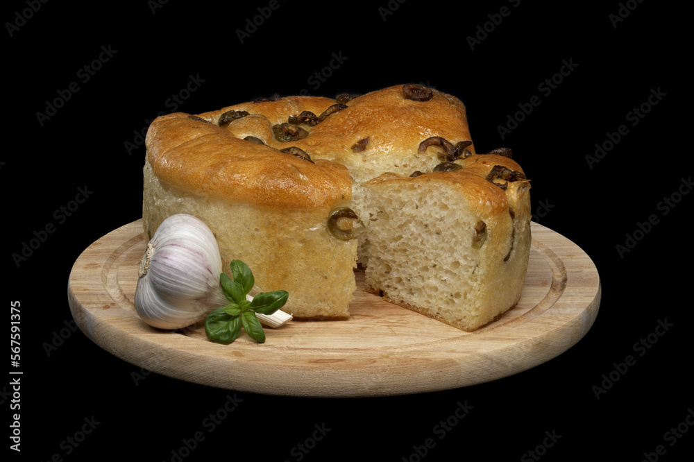 Focaccia bread with olives on black background