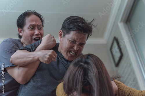 Schilderij op canvas A man stops and holds back a furious guy from hitting his abused wife