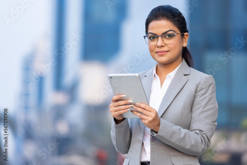 Confident businesswoman using a digital tablet.