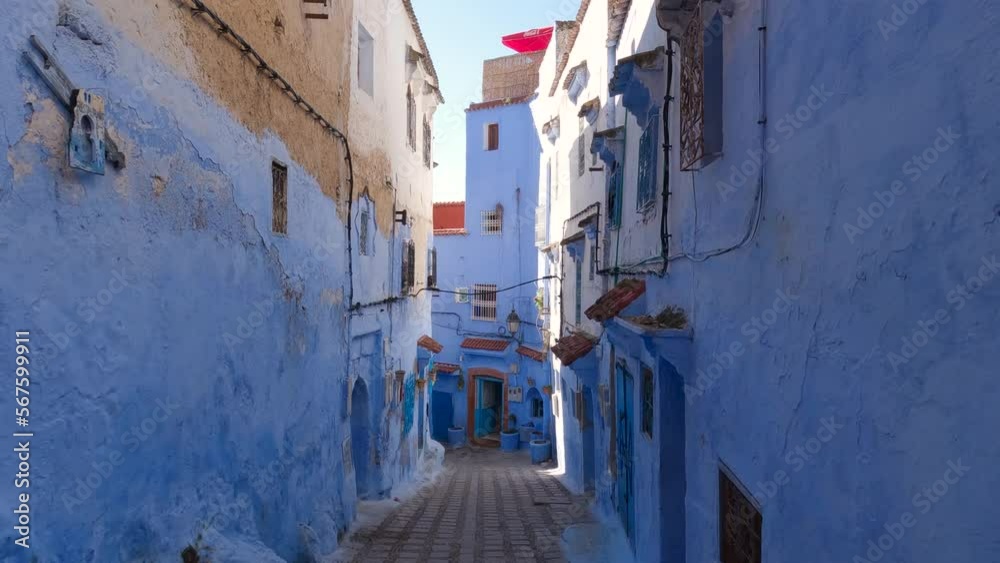 View Looking Up At Half Blue Painted Wall In Chefchaouen With Tilt Down To Reveal Empty Street View Looking Up At Half Blue Painted Wall In Chefchaouen With Tilt Down To Reveal Empty Street