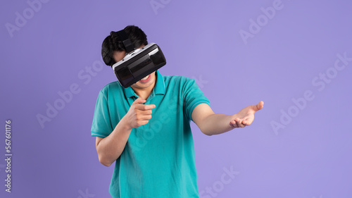 image of asian man wearing virtual reality glasses on purple background