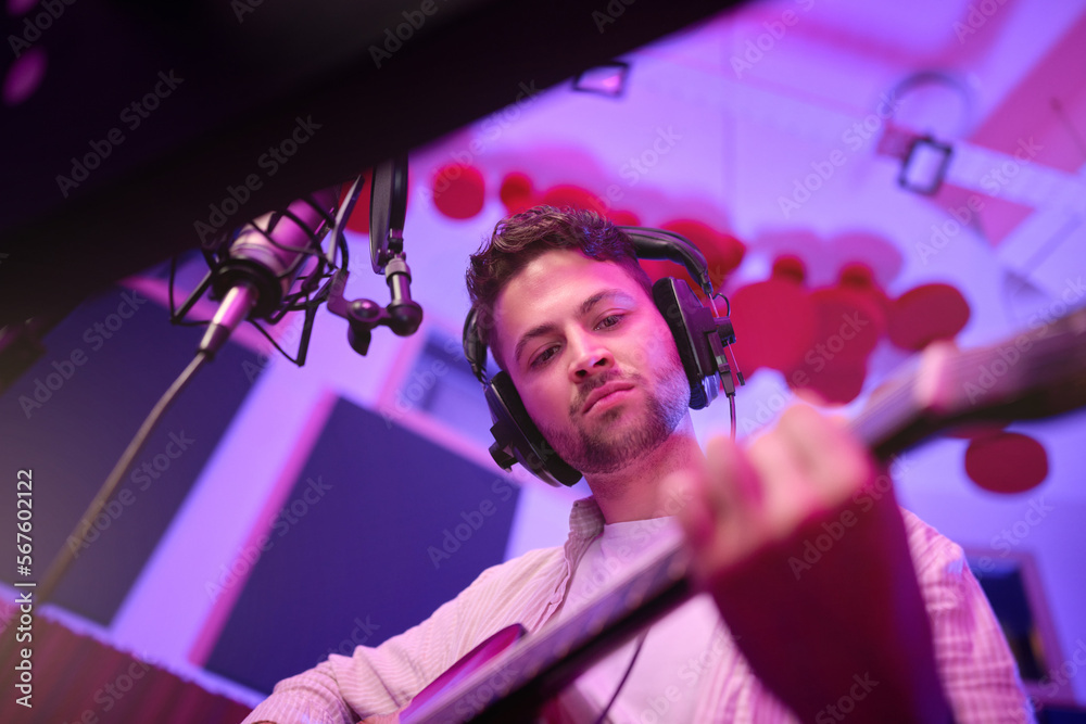 man-musician-or-guitar-in-neon-studio-recording-production-or-live