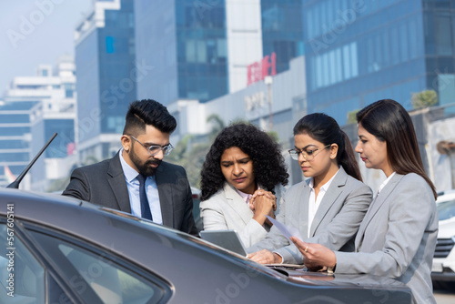 Sticker Group of businesspeople going through a report at work