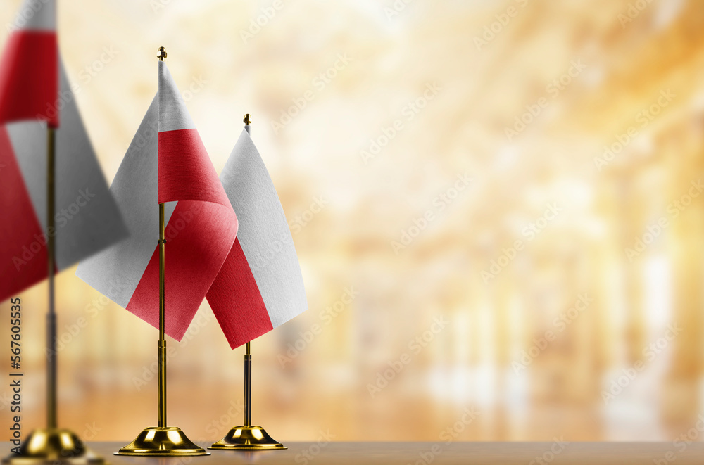 Small flags of the Poland on an abstract blurry background