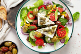 Greek village salad horiatiki with feta cheese, olives, cherry tomato, cucumber and red onion, vegeterian mediterranean food, low calories dieting meal.