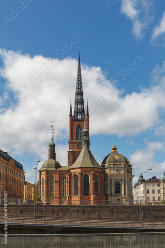 Stockholm, Sweden - June, 15, 2022: Riddarholmen Church and ornamented spire with scenic street view