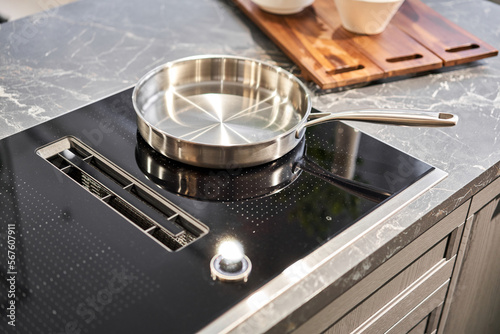 Vászonkép New cookware set on black induction hob in modern kitchen