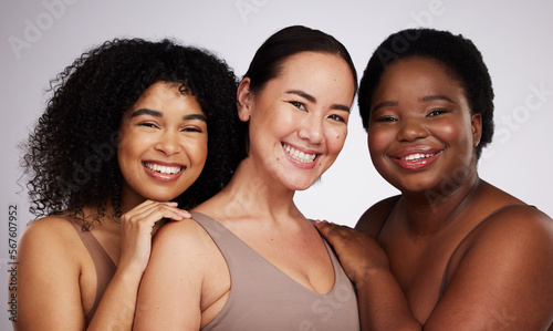 Portrait, diversity and women with skincare, smile and bonding together on grey studio background. Face, multiracial and females with cosmetics, support or solidarity with body positivity on backdrop