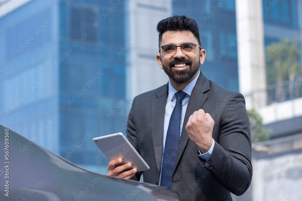 Portrait of Indian businessman with digital tablet outdoors in city. Portrait of Indian businessman with digital tablet outdoors in city.