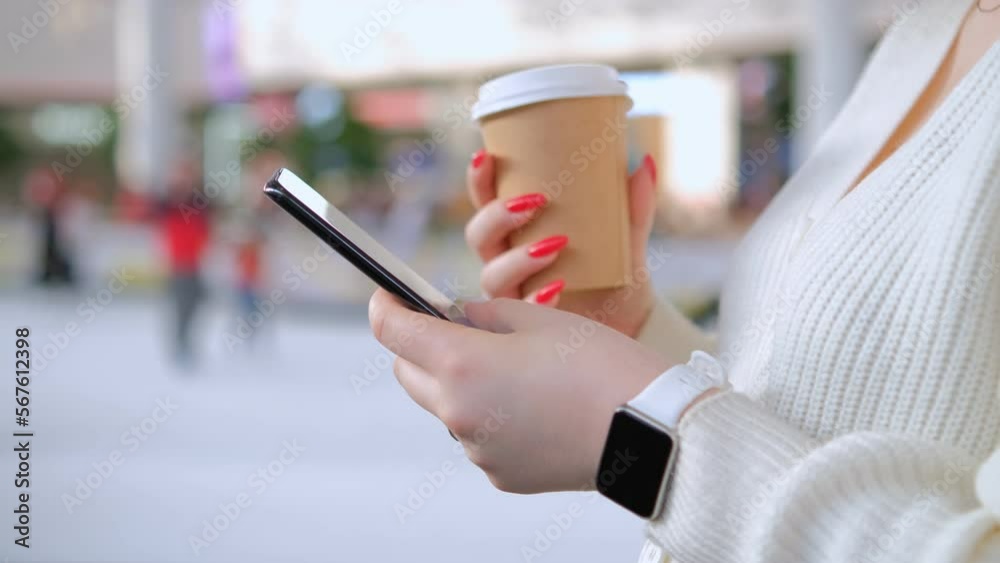 Beautiful girl in the mall. Surfing the Internet, reading messages on a woman's hand in a smart watch. Modern lifestyle concept 4K Beautiful girl in the mall. Surfing the Internet, reading messages on a woman's hand in a smart watch. Modern lifestyle concept 4K