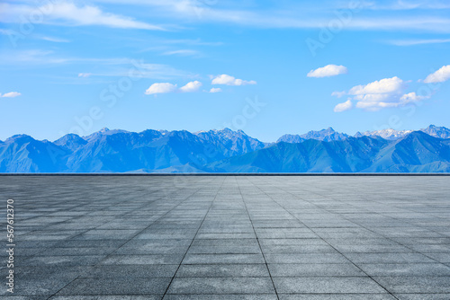 Empty square floor and green mountain with sky clouds background © ABCDstock