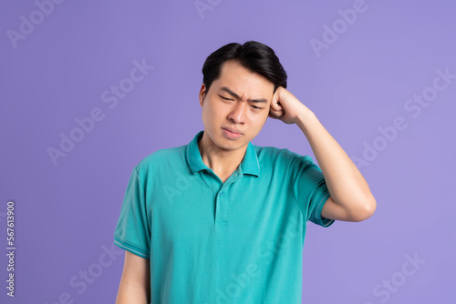 portrait of asian man posing on purple background © 1112000